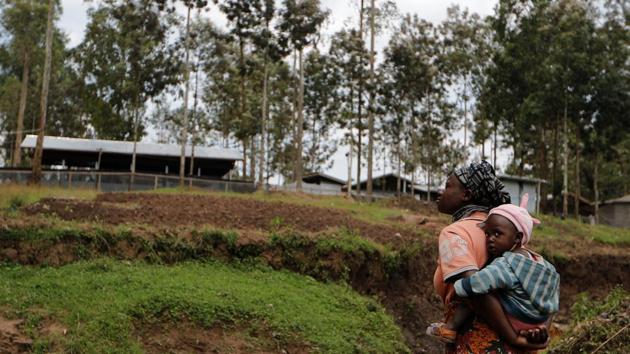 A woman holds her daughter in front of an Ebola treatment center (ETC) in Katwa. When Kavugho tried to return to work as a seamstress in her hometown of Butembo, customers were too scared of catching the disease, despite doctors’ assurances she was no longer contagious. Instead she found work as a caregiver to children suspected of having Ebola only to be accused by neighbours of faking her illness to get the job. (Zohra Bensemra / REUTERS)