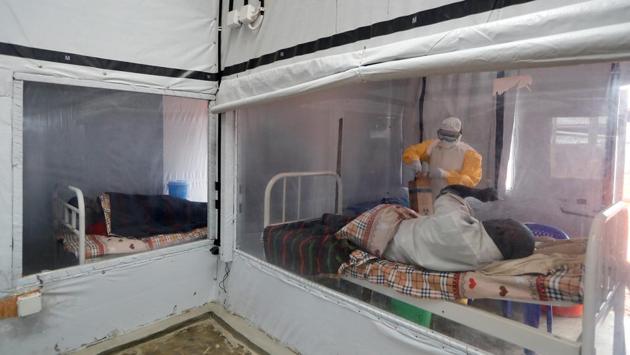 Moise Vaghemi, 33, a father of two and an Ebola survivor who works as a nurse, tends to a patient suspected to be suffering from Ebola, inside the Biosecure Emergency Care Unit (CUBE) at an ETC in Katwa. As of this month, more than 1,000 people have survived the 14-month Ebola outbreak in DRC, the world’s second deadliest, helped by new medicines that have proven effective when administered early. (Zohra Bensemra / REUTERS)