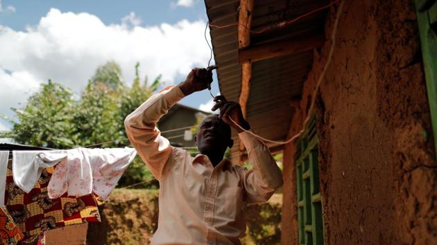 Moise Vaghemi fixes electric cables outside his house. Accusations are common in eastern Congo, where many residents see the outbreak as a money-making scheme made up by the government and outside organisations. “I was even accused of having received money to bring people from my community to the treatment centre, to kill them with the virus and then sell their organs abroad,” said Vaghemi. (Zohra Bensemra / REUTERS)