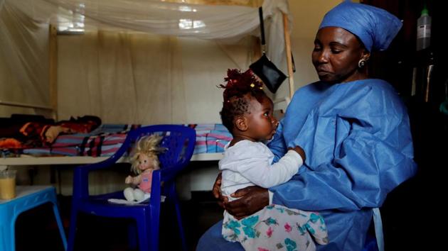 Kitambala Kavugho, 38, an Ebola survivor, takes care of one-year-old Chamim, an orphan whose mother recently died of Ebola in Beni. Some say they draw strength from returning to treatment centres to work as caregivers for children with Ebola, many of whom have lost parents and siblings to the disease. (Zohra Bensemra / REUTERS)