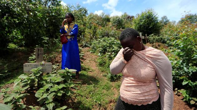Eugenie Katungu Kavuya, 21, and her cousin Noella Masika Vinyinyi, 30, both Ebola survivors and caregivers, react as they stand next to Kavuya’s parents’ graves, who died of Ebola, at Vuhunga cemetery in Katwa. The antibodies developed during their illness mean they can spend entire days with patients wearing only partial protective gear and not the stifling head-to-toe suits donned by doctors and nurses. (Zohra Bensemra / REUTERS)