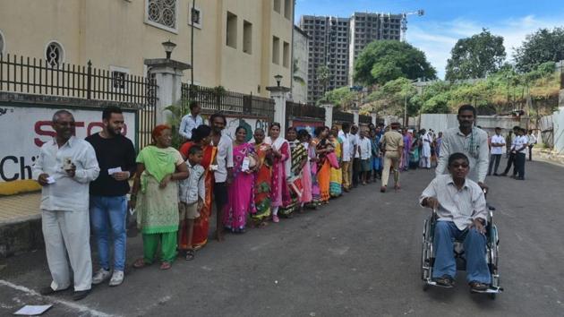 People queue at a polling station to cast their vote at Pawar Public School, at Chandivali in Mumbai. The state assembly elections for Haryana and Maharashtra began at 7 am today and will continue till 6 pm in the evening. The polling is for 90 seats of Haryana and 288 constituencies of Maharashtra and has largely remained peaceful, with each major party predicting its win in the elections. (Satyabrata Tripathy / HT Photo)