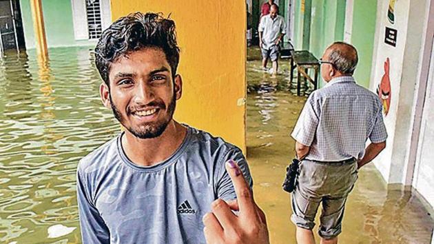 A man shows his finger marked with indelible ink after casting his vote at a polling station inundated in rain water following heavy rainfall during the bypolls for assembly seats in Ernakulam district. (Photo: PTI) A man shows his finger marked with indelible ink after casting his vote at a polling station inundated in rain water following heavy rainfall during the bypolls for assembly seats in Ernakulam district. (Photo: PTI)
