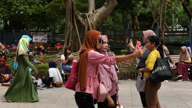 Jochel, an Indonesian migrant worker usually spends her sole day off in Hong Kong’s parks, chatting with friends and video-calling loved ones back home. But this summer, her downtime keeps getting disrupted -- by protests and tear gas. “My eyes were very painful,” Jochel said of the first time she found herself caught up in tear gas clouds while having a picnic with friends in Victoria Park. (Mohd Rasfan / AFP)