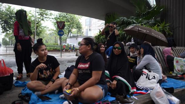 Migrant workers gathered together on their day off at Victoria Park. Yet despite Hong Kong’s uncertain future, many domestic helpers said they had no plan to leave any time soon. “Our employers still need us and we also still need the job,” said Sandy, who is financially supporting her parents back in Indonesia. (Mohd Rasfan / AFP)