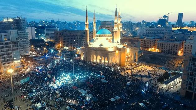 An areal view taken shows protesters rallying in downtown Beirut, on the fifth day of demonstrations. Prime Minister Saad al-Hariri, in a televised speech, said the new measures might not meet the protesters’ demands but were a start towards achieving some of them. The government must work to recover trust, he said. “We don’t believe that they can change in two days,” said a 55-year-old jeweller. (AFP)