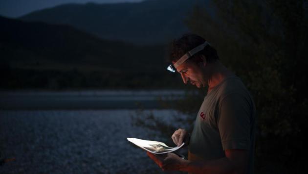 Benedikt Baeumler, 43, a German advertising executive kayaking the length of the Vjosa River, checks his map after setting up camp. Earlier, he had been ambivalent about hydropower projects. But what he saw at one of the dam sites changed his mind. “It was really unbelievable what they did to nature, removing entire parts of the mountain,” he said. “I hope this dam is never built.” (Felipe Dana / AP)