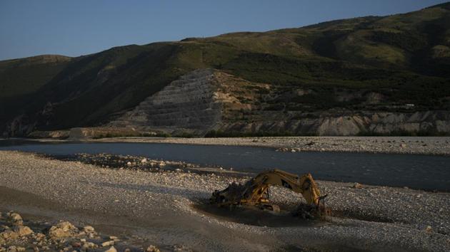 An abandoned bulldozer sits on the banks of the Vjosa River at the construction site of the Kalivac dam in Albania. With an aim to produce much-needed electricity for one of Europe’s poorest countries, the government has set in motion plans to dam the Vjosa and its tributaries. Vjosa, which is one of Europe’s last wild rivers, runs the risk of interruption in its flow and the life in and around it. (Felipe Dana / AP)