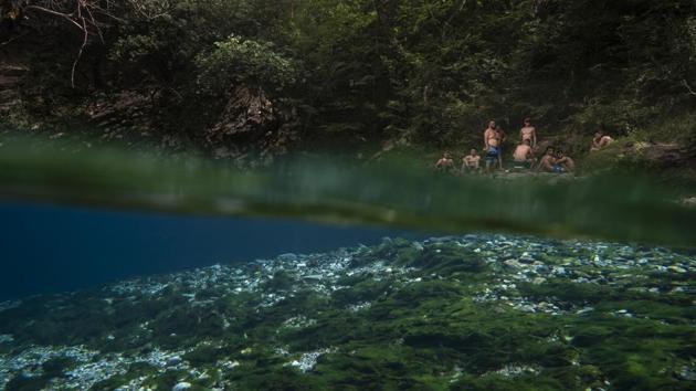 Residents sit on the shore of the Vjosa River next to a spring in the Kelcyre Gorge. The government’s move to dam the river is part of a world hydropower boom, mainly in Southeast Asia, South America, Africa and less developed parts of Europe. In the Balkans alone, about 2,800 projects to tame rivers are underway or planned — a “dam tsunami,” says Olsi Nika of EcoAlbania, a nonprofit that opposes the projects. (Felipe Dana / AP)