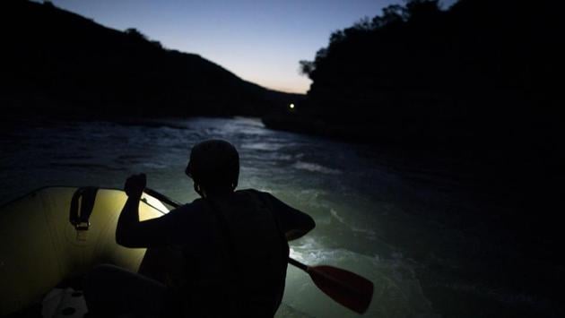 A river rafting guide paddles at dusk. “It’s like humans,” said Elton Pashollari, a river rafting guide whose clients are increasingly attracted by the Vjosa’s wildness. “What happens if one of your arteries, it stops, blood doesn’t circulate anymore? It’s the same thing with the Vjosa.” (Felipe Dana / AP)