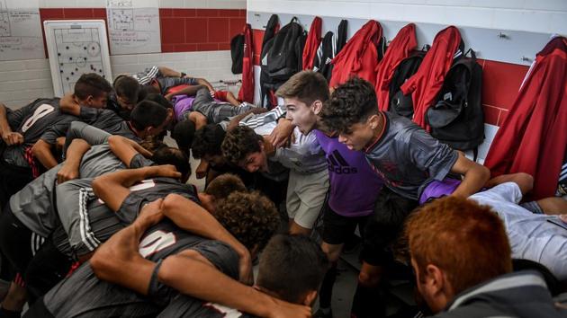 Benfica’s under 15 players cheer each other before a match Benfica against Sacavenense at Benfica’s Football Academy. Financially, the sales of players “made in Seixal” have already cashed in nearly half a billion euros and Benfica posted profits in 2018 for a fifth consecutive year. (Patricia De Melo Moreira / AFP)