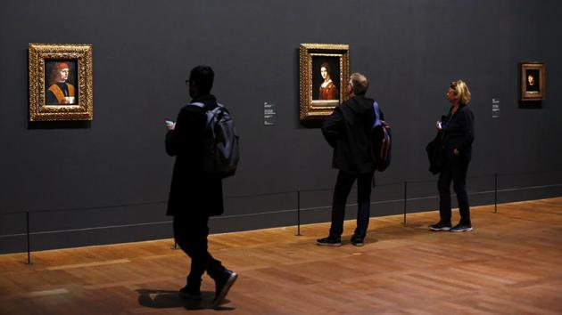 Journalists watch the painting “Portrait of a Musician”, left, and “La Belle Ferronniere”, centre, by Leonardo da Vinci. The two curators, who are heads of the Louvre museum’s painting and graphic arts departments, have also included infrared reflectographs that offer an insight into the master painter’s techniques. The show runs until February 24. (Thibault Camus / AP) Journalists watch the painting “Portrait of a Musician”, left, and “La Belle Ferronniere”, centre, by Leonardo da Vinci. The two curators, who are heads of the Louvre museum’s painting and graphic arts departments, have also included infrared reflectographs that offer an insight into the master painter’s techniques. The show runs until February 24. (Thibault Camus / AP)