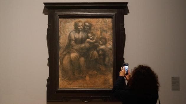 A woman looks at the drawing “The Virgin, the Child Jesus with Saint Anne and Saint John the Baptist”, during the opening of the show. “We wished, in order to pay homage to the artist, to be able to show the entirety of Leonardo da Vinci’s career and his development and to explain, ultimately, the sense of his life,” the second curator Vincent Delieuvin said. (Francois Guillot / AFP) A woman looks at the drawing “The Virgin, the Child Jesus with Saint Anne and Saint John the Baptist”, during the opening of the show. “We wished, in order to pay homage to the artist, to be able to show the entirety of Leonardo da Vinci’s career and his development and to explain, ultimately, the sense of his life,” the second curator Vincent Delieuvin said. (Francois Guillot / AFP)