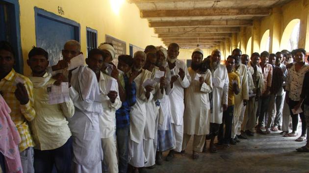 People stand in queue to cast their vote during Haryana Assembly election, at Mahu village, Firozpur Jhirka constituency, on Monday, October 21, 2019.(Yogendra Kumar/HT PHOTO)