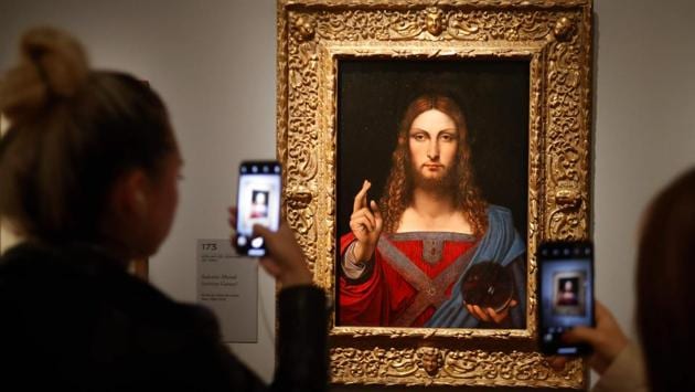 People take pictures with mobile phone at an oil painting by Atelier Leonardo da Vinci’s “Salvator Mundi” (Version Ganay), during the opening of the exhibition. (Francois Guillot / AFP) People take pictures with mobile phone at an oil painting by Atelier Leonardo da Vinci’s “Salvator Mundi” (Version Ganay), during the opening of the exhibition. (Francois Guillot / AFP)