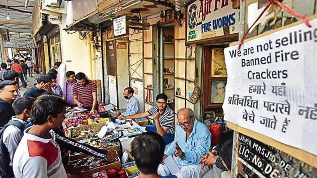 A signage board hangs at a store selling green crackers ahead of Diwali celebrations, in Chandni Chowk, New Delhi on Wednesday.(Photo by Sanchit Khanna/ Hindustan Times)