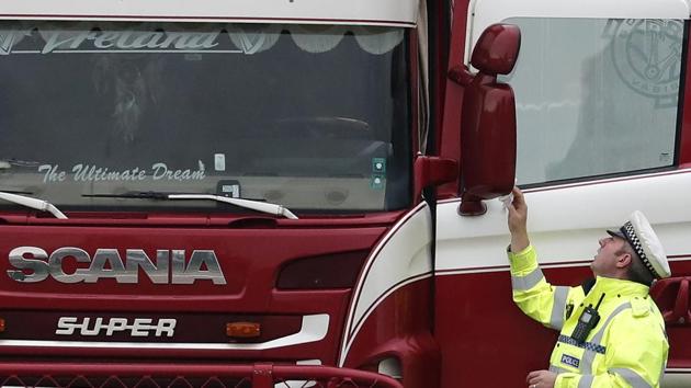 A police officer wipes the wing mirror of a truck that was found to contain a large number of dead bodies. (AP Photo) A police officer wipes the wing mirror of a truck that was found to contain a large number of dead bodies. (AP Photo)