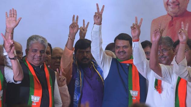 Maharashtra CM Devendra Fadnavis, MP Ramdas Athawle and BJP state president Chandrakant Patil show the victory sign outside BJP office in Mumbai. Fadnavis won from his home turf Nagpur South-West. While Uddhav Thackeray has said that BJP needs to respect the 50-50 formula which was already decided, Fadnavis has refused to confirm what is the formula that was zeroed in. (Vijayanand Gupta / HT Photo) Maharashtra CM Devendra Fadnavis, MP Ramdas Athawle and BJP state president Chandrakant Patil show the victory sign outside BJP office in Mumbai. Fadnavis won from his home turf Nagpur South-West. While Uddhav Thackeray has said that BJP needs to respect the 50-50 formula which was already decided, Fadnavis has refused to confirm what is the formula that was zeroed in. (Vijayanand Gupta / HT Photo)