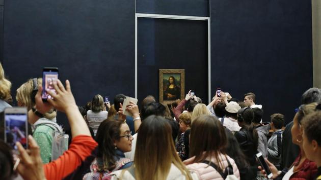 The Mona Lisa is a singular sensation at the Louvre’s retrospective, starring in a virtual reality experience because she cannot appear in person. Organisers of the show decided to leave the masterpiece in its usual home, the Salle des Etats, fearing crowd-control problems. Instead, visitors can enjoy a virtual “tete-a-tete” with the 24-year-old wife of a wealthy Florentine silk merchant thanks to the immersion experience. (Thibault Camus / AP) The Mona Lisa is a singular sensation at the Louvre’s retrospective, starring in a virtual reality experience because she cannot appear in person. Organisers of the show decided to leave the masterpiece in its usual home, the Salle des Etats, fearing crowd-control problems. Instead, visitors can enjoy a virtual “tete-a-tete” with the 24-year-old wife of a wealthy Florentine silk merchant thanks to the immersion experience. (Thibault Camus / AP)