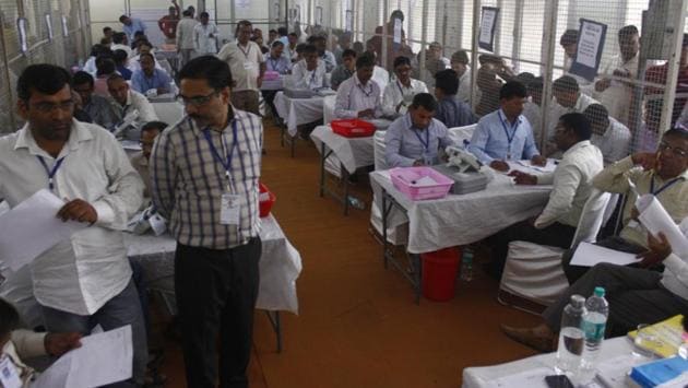 Election officials count votes at a counting centre in Gurugram, Haryana. The counting for both the election results commenced at 8 am. As no party has gained majority in the state, the JJP, which has won 10 seats currently, may play a key role in formation of the next government. (Yogendra Kumar / HT Photo) Election officials count votes at a counting centre in Gurugram, Haryana. The counting for both the election results commenced at 8 am. As no party has gained majority in the state, the JJP, which has won 10 seats currently, may play a key role in formation of the next government. (Yogendra Kumar / HT Photo)