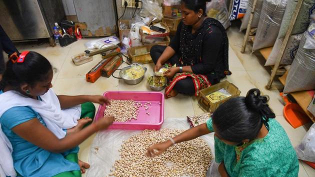 Staff sort pistachios to pack into gift boxes with sweets at a factory in Mumbai. Even orders for the cheapest items -- small boxes of Indian almonds, walnuts, and cashews -- have fallen by more than half, Shah said, bringing down the firm’s annual turnover by 35% and leaving him with no funds for employee bonuses, another Diwali tradition. “Diwali is not only the festival of lights but also represents economic prosperity,” Shah said. (Indranil Mukherjee / AFP)