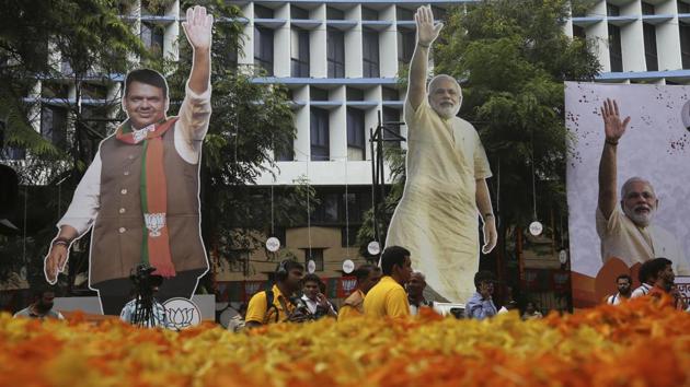 Journalists stand near giant cutouts of Prime Minister Narendra Modi and Maharashtra CM Devendra Fadnavis outside the office of the BJP in Mumbai. In Maharashtra, the BJP-Shiv Sena alliance has passed the majority seat share. But it’s still unclear if they would form the government in alliance. On the other hand, Haryana is headed for a hung assembly as none of the three major parties has reached the majority mark to form the state government. (Rafiq Maqbool / AP) Journalists stand near giant cutouts of Prime Minister Narendra Modi and Maharashtra CM Devendra Fadnavis outside the office of the BJP in Mumbai. In Maharashtra, the BJP-Shiv Sena alliance has passed the majority seat share. But it’s still unclear if they would form the government in alliance. On the other hand, Haryana is headed for a hung assembly as none of the three major parties has reached the majority mark to form the state government. (Rafiq Maqbool / AP)