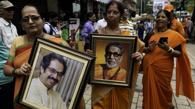 Shiv Sena supporters hold a pictures of party chief Uddhav Thackeray and Sena founder Bal Thackeray during celebrations at Sena Bhavan in Mumbai. To form the government in Maharashtra, the winning party or alliance needs to win a minimum of 145 seats, while the majority mark in Haryana is 46 seats. (Satish Bate / HT Photo) Shiv Sena supporters hold a pictures of party chief Uddhav Thackeray and Sena founder Bal Thackeray during celebrations at Sena Bhavan in Mumbai. To form the government in Maharashtra, the winning party or alliance needs to win a minimum of 145 seats, while the majority mark in Haryana is 46 seats. (Satish Bate / HT Photo)