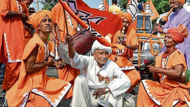 Supporters of BJP candidate from Gharaunda, Harvinder Singh Kalyan celebrate his win in the Assembly election in Karnal on Thursday.(Photo: PTI)