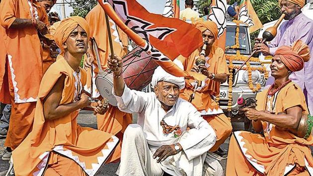 Supporters of BJP candidate from Gharaunda, Harvinder Singh Kalyan celebrate his win in the Assembly election, in Karnal.(Photo: PTI)