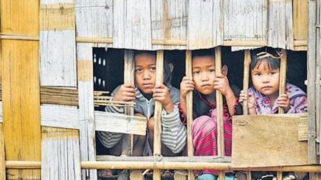 As per the instructions of the MHA, supplies of ration and cash benefits to the Bru camps were stopped since October 1, two days before the repatriation began. Over 37,000 Bru people had taken shelter in Tripura to escape an ethnic clash in Mizoram in 1997. In this file picture, 3 Bru children seen at a relief camp in Northern part of Tripura.(HT Archive)