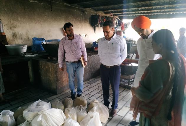 Health officials conducting a raid at a sweets shop on Fatehgarh Sahib-Sirhind road on Friday.(HT PHOTO)