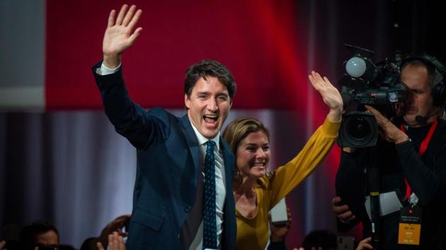 Canadian Prime Minister Justin Trudeau and his wife Sophie Grégoire Trudeau arrive to celebrates his victory with his supporters at the Palais des Congres in Montreal during Team Justin Trudeau 2019 election night event in Montreal, Canada. (Sebastien St-Jean / AFP)
