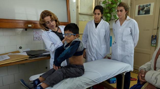 Brigida Simaniz (not pictured) watches over her son Nicholas, 7, as he is examined by Dr Laura Lagrutta. "I was scared when they told me the diagnosis because I did not know it existed. I always followed the treatment as the doctors said for fear of infecting my children," said Simaniz. "Even though it was cold at night, I opened the windows of the room to circulate the air." (Magali Druscovich / REUTERS) Brigida Simaniz (not pictured) watches over her son Nicholas, 7, as he is examined by Dr Laura Lagrutta. "I was scared when they told me the diagnosis because I did not know it existed. I always followed the treatment as the doctors said for fear of infecting my children," said Simaniz. "Even though it was cold at night, I opened the windows of the room to circulate the air." (Magali Druscovich / REUTERS)