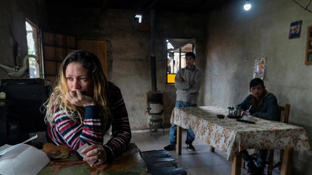 Cristian Molina (R), 26, drinks a cup of mate with his siblings Xoana (L) and Manuel in the shantytown of Lujan. He shares living spaces with his parents, six siblings and four nephews. Doctors think one brother contracted the disease in prison before spreading it around the family when he returned home. (Magali Druscovich / REUTERS) Cristian Molina (R), 26, drinks a cup of mate with his siblings Xoana (L) and Manuel in the shantytown of Lujan. He shares living spaces with his parents, six siblings and four nephews. Doctors think one brother contracted the disease in prison before spreading it around the family when he returned home. (Magali Druscovich / REUTERS)