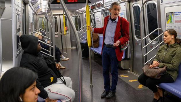 “I know you don’t want me standing here shouting at you in the subway and I really don’t want to do it myself,” he tells passengers on a Brooklyn-bound Q train. “But I feel I have no choice. All of us need to wake up and not look away because this is so painful,” pleads the grey-haired McLachlan, wearing a dandy red blazer. (Don Emmert / AFP)
