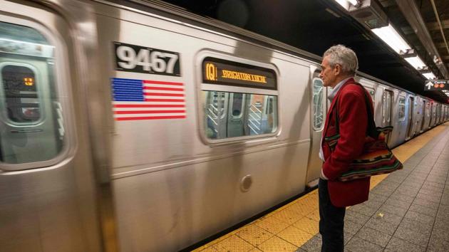 Richard McLachlan waits to board a train. The sexagenarian, long concerned about the planet, joined Extinction Rebellion’s New York outfit after watching campaigners in London shut down parts of the British capital in April. A few weeks later, McLachlan -- who has lived in New York for seven years -- was traveling on the subway when he struck upon his idea. (Don Emmert / AFP)