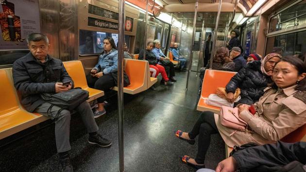 Subway passengers listen to McLachlan. New Yorkers are used to hearing speeches when they travel underground, but they are usually from needy people seeking a dollar or two to get by. After his first attempt McLachlan, a retired public servant who has also worked as a sheep shearer, a jeweler and a truck driver, refined his speech. (Don Emmert / AFP)