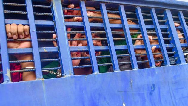 A suspect inside a vehicle reacts following a verdict that sentenced 16 people to death over the murder of a 19-year-old female student, in Feni, Bangladesh. A court sentenced 16 people to death on October 24 over the murder of a 19-year-old female student burnt alive in April that provoked outrage across the country. (Munir Uz Zaman / AFP)