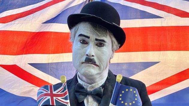 A Brexit activist dressed as the late English comic actor Charlie Chaplin, holds a Union and an EU flag as he protests outside the Houses of Parliament in London, England as MPs debate the second reading of the Government’s European Union (Withdrawal Agreement) Bill. (Daniel Leal-Olivas / AFP)