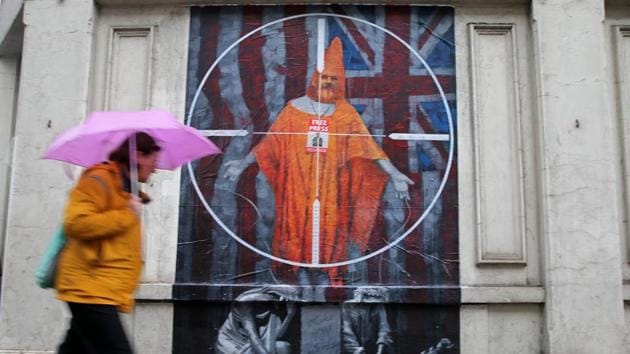 A pedestrian passes a graffiti mural of WikiLeaks founder Julian Assange, near Westminster Magistrates Court in London, England, ahead of a case management hearing in Assange’s case. (Isabel Infantes / AFP)
