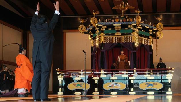 Prime Minister Shinzo Abe shouts banzai cheer for Emperor Naruhito (2nd R) during the enthronement ceremony where emperor officially proclaimed his ascension to the Chrysanthemum Throne at the Imperial Palace in Tokyo. Japan. (Japanese Government / AFP)