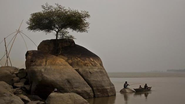 A fisherman sits on a rock to catch fish in the river Brahmaputra in Kasoshila village on the outskirts of Guwahati, Assam. (Anupam Nath / AP) A fisherman sits on a rock to catch fish in the river Brahmaputra in Kasoshila village on the outskirts of Guwahati, Assam. (Anupam Nath / AP)