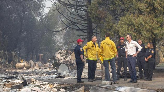 California Governor Gavin Newsom (in white) has had to declare a state of emergency in Sonoma and Los Angeles counties. Newsom travelled to Sonoma on Friday to survey areas impacted by the Kincade Fire which has grown to around 23,700 acres and was only 5% contained as of Friday evening. Newsom told reporters the area looked like a “war zone.” (Karl Mondon / San Jose Mercury News via AP) California Governor Gavin Newsom (in white) has had to declare a state of emergency in Sonoma and Los Angeles counties. Newsom travelled to Sonoma on Friday to survey areas impacted by the Kincade Fire which has grown to around 23,700 acres and was only 5% contained as of Friday evening. Newsom told reporters the area looked like a “war zone.” (Karl Mondon / San Jose Mercury News via AP)