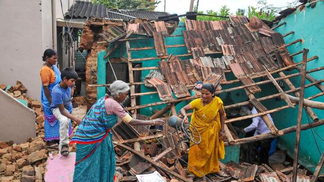 Residents salvage their household items after a house collapsed following rains, in Chikmagalur district of Karnataka. The effects of cyclone Kyarr passing along the coast of Karnataka have been felt in Dakshina Kannada district with the entire region experiencing heavy rains throughout Thursday night and intermittently on Friday. Trees were uprooted in gusty winds, damaging houses in many places. (PTI)
