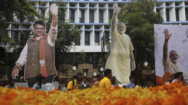 Journalists stand near giant cutouts of Prime Minister Narendra Modi and Maharashtra Chief Minister Devendra Fadnavis outside the office of the Bharatiya Janata Party in Mumbai, Maharashtra as counting for Maharashtra state elections was being held. (Rafiq Maqbool / AP) Journalists stand near giant cutouts of Prime Minister Narendra Modi and Maharashtra Chief Minister Devendra Fadnavis outside the office of the Bharatiya Janata Party in Mumbai, Maharashtra as counting for Maharashtra state elections was being held. (Rafiq Maqbool / AP)
