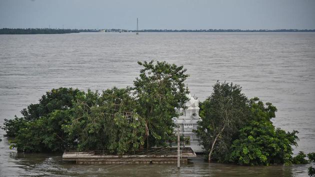 A Shiva temple is seen submerged in floodwater following the release of excess water from Prakasam Barrage at Tadepalli in Guntur District, on October 25. Crops in several hundred acres remained inundated in Guntur and Krishna districts of Andhra Pradesh due to a sudden flood surge in river Krishna in the last two days, officials said on Friday. No loss of life was reported. (PTI)