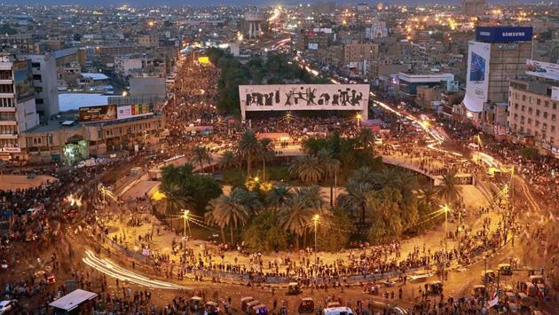 Anti-government protesters gather in Tahrir square during a demonstration in Baghdad. Hundreds of protesters hunkered down in the Iraqi capital’s Tahrir Square on Sunday, defying another night of tear gas and shuttered roads as they pledged to “weed out” the political class. (AP)