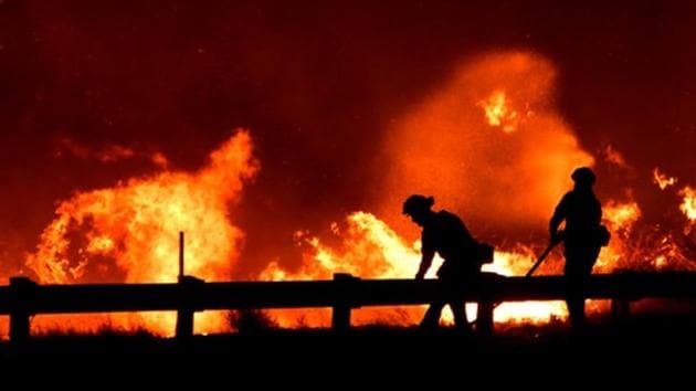 Firefighters battle a fire, as a wind driven wildfire continues to burn in Canyon Country north of Los Angeles, California. (Reuters Photo) Firefighters battle a fire, as a wind driven wildfire continues to burn in Canyon Country north of Los Angeles, California. (Reuters Photo)