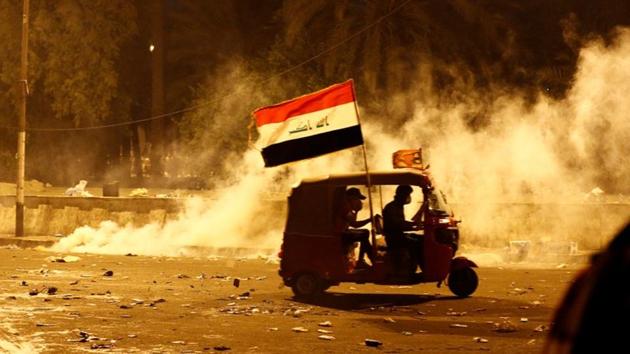 A tuk-tuk drives away from tear gas fired by Iraqi security forces. The persistent protests have kept the pressure up on Abdel Mahdi, as has a new sit-in by parliamentarians tied to populist cleric Moqtada al-Sadr. His Saeroon bloc, parliament’s largest, launched the open-ended measure late on Saturday in order to achieve protester demands, lawmakers told AFP. (Thaier Al-Sudani / REUTERS)