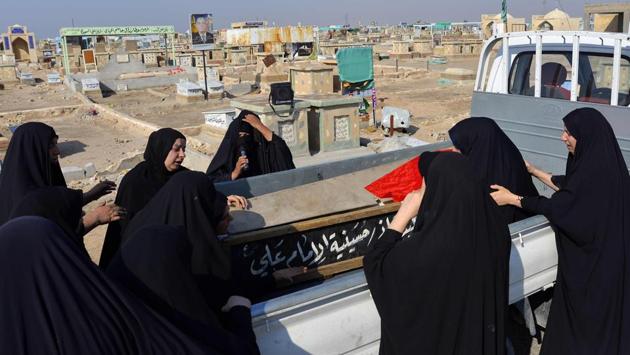Women mourn over the coffin of a demonstrator, reportedly killed the day before during anti-government protests in the eastern city of Diwaniya, during his funeral in Najaf. The protestors have continued to gather despite a rapidly rising casualty toll, with more than 60 people dead since this second wave of anti-government protests kicked off Thursday. (AFP)